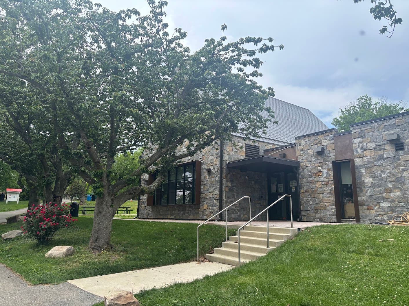 Lafayette-Pointer Recreation Center stone exterior with a flowering tree